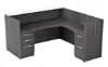 L shaped reception desk with white glass transaction counter