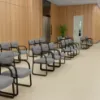 	Boss Grey LeatherPlus guest chair with curved arms, contoured cushions, black steel sled base, and reception seating design
