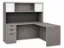 L-shaped executive desk with hutch, glass doors, credenza return, box file pedestal, and fabric tack board