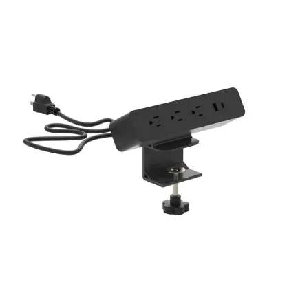 Black desktop power module with AC outlets and USB charging ports installed in a modern office desk.