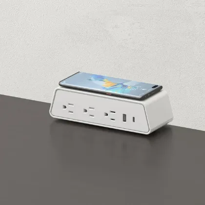 Desktop power module with integrated wireless phone charger, three AC outlets, USB-A, USB-C ports, and C-clamp mounting for office desks and conference tables.