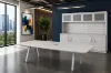 Modern executive conference table with powder-coated metal legs and matching storage credenza featuring a glass door hutch in a professional boardroom.