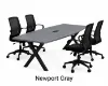 Executive boat-shaped conference table with powder-coated metal X base and Orion mesh conference chairs in a modern boardroom.
