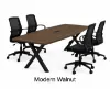 Executive boat-shaped conference table with powder-coated metal X base and Orion mesh conference chairs in a modern boardroom.