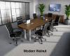 	Modern conference room furniture set with boat shaped conference table, locking storage credenza, and black leather conference chairs.